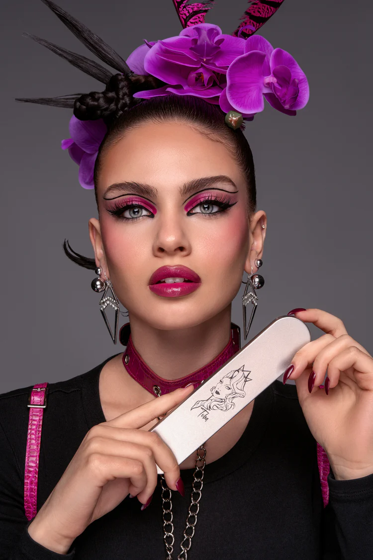 Fashion portrait with vibrant purple orchid headpiece and dramatic makeup