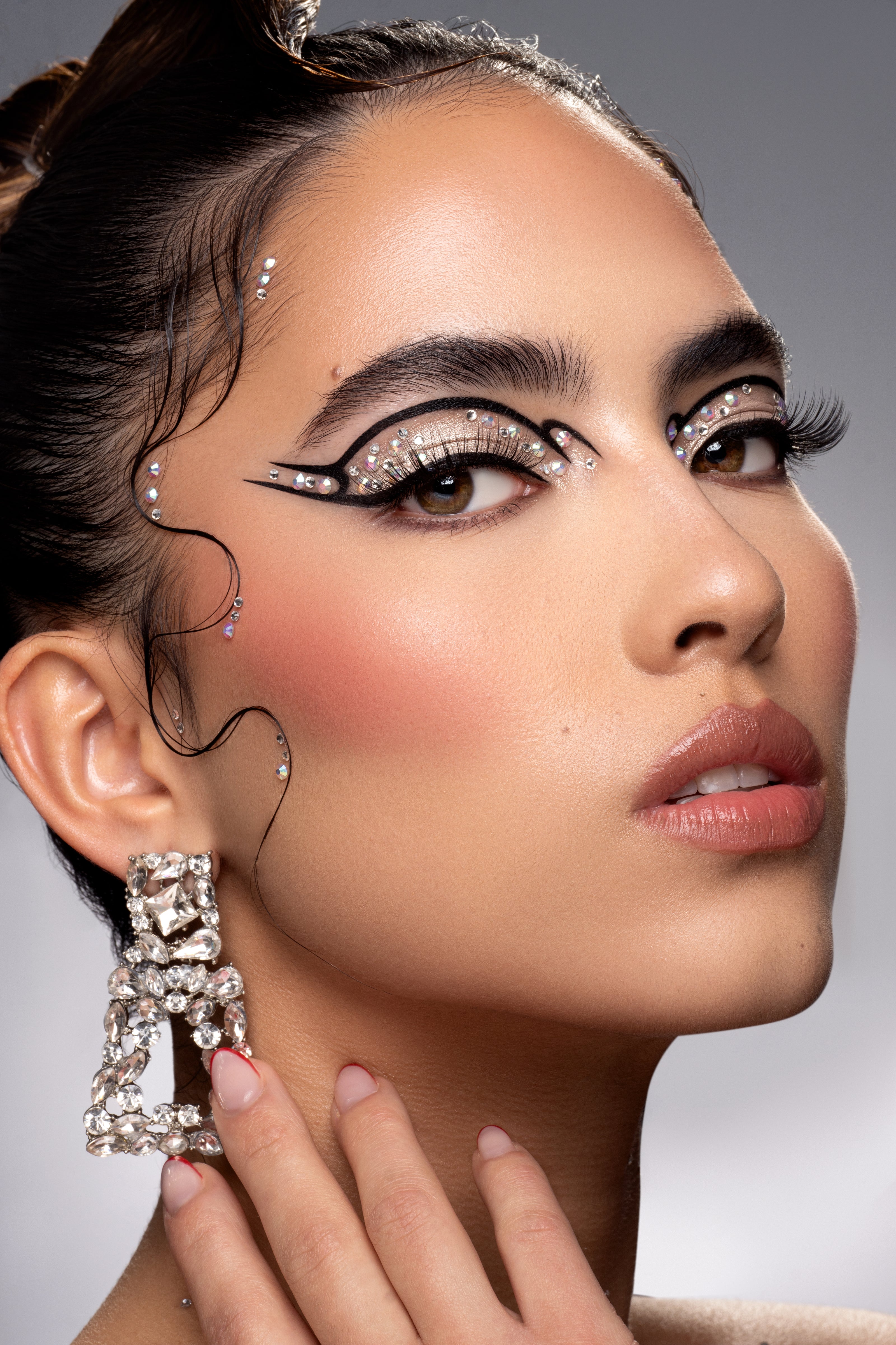 Dramatic makeup with glittery eyeshadow and crystal embellishments
